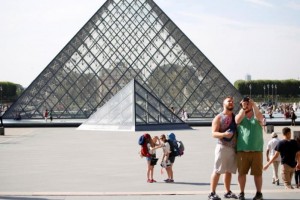 Tourists and visitors stand in front of the Louvre Pyramid designed by Chinese-born U.S. Architect Ieoh Ming Pei in Paris, France, September 13, 2016. REUTERS/Charles Platiau